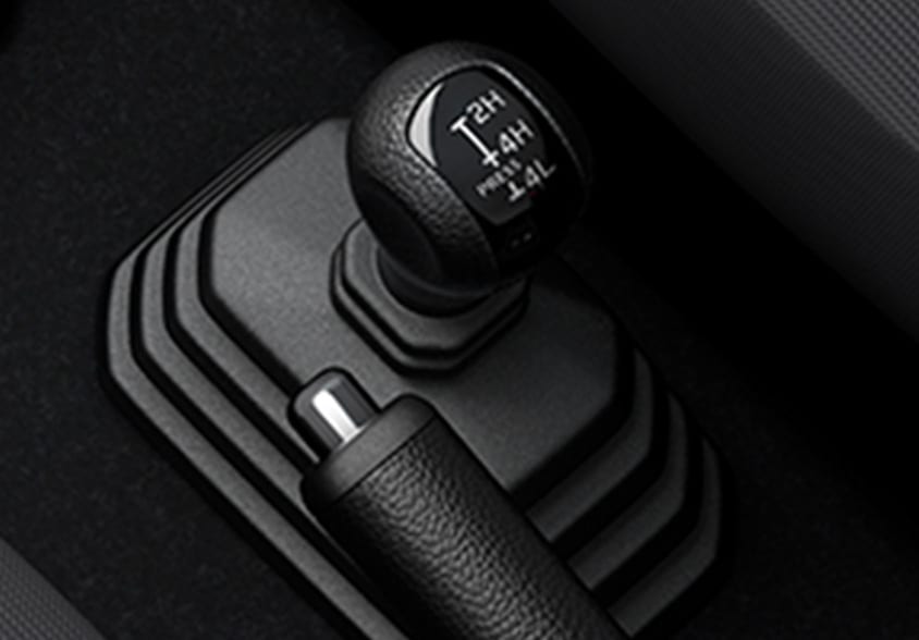 Close-up of the Suzuki Jimny's separate 4x4 lever, marked 2H, 4H and 4L