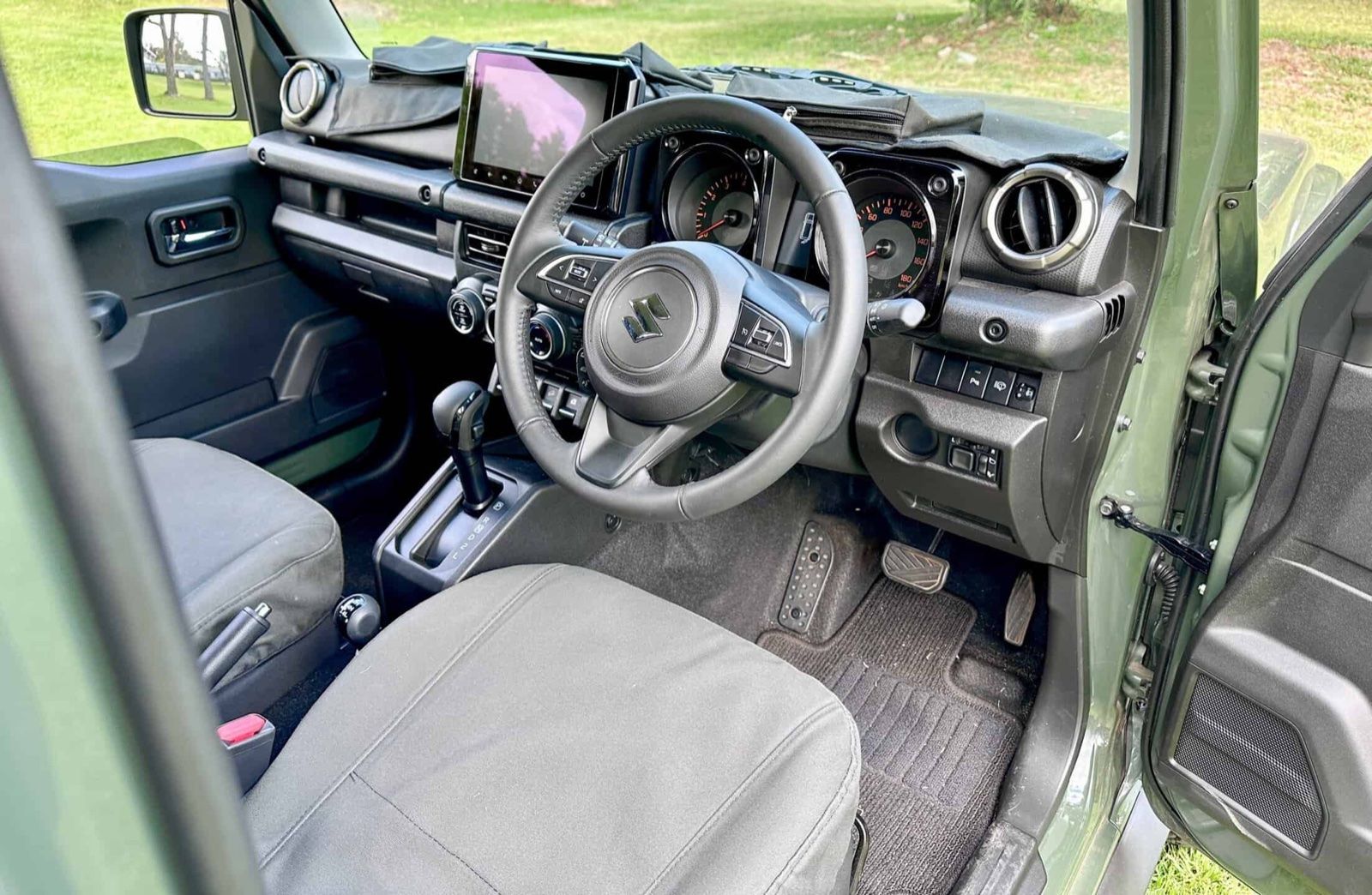 The interior and dashboard of a Suzuki Jimny 5-door JC74