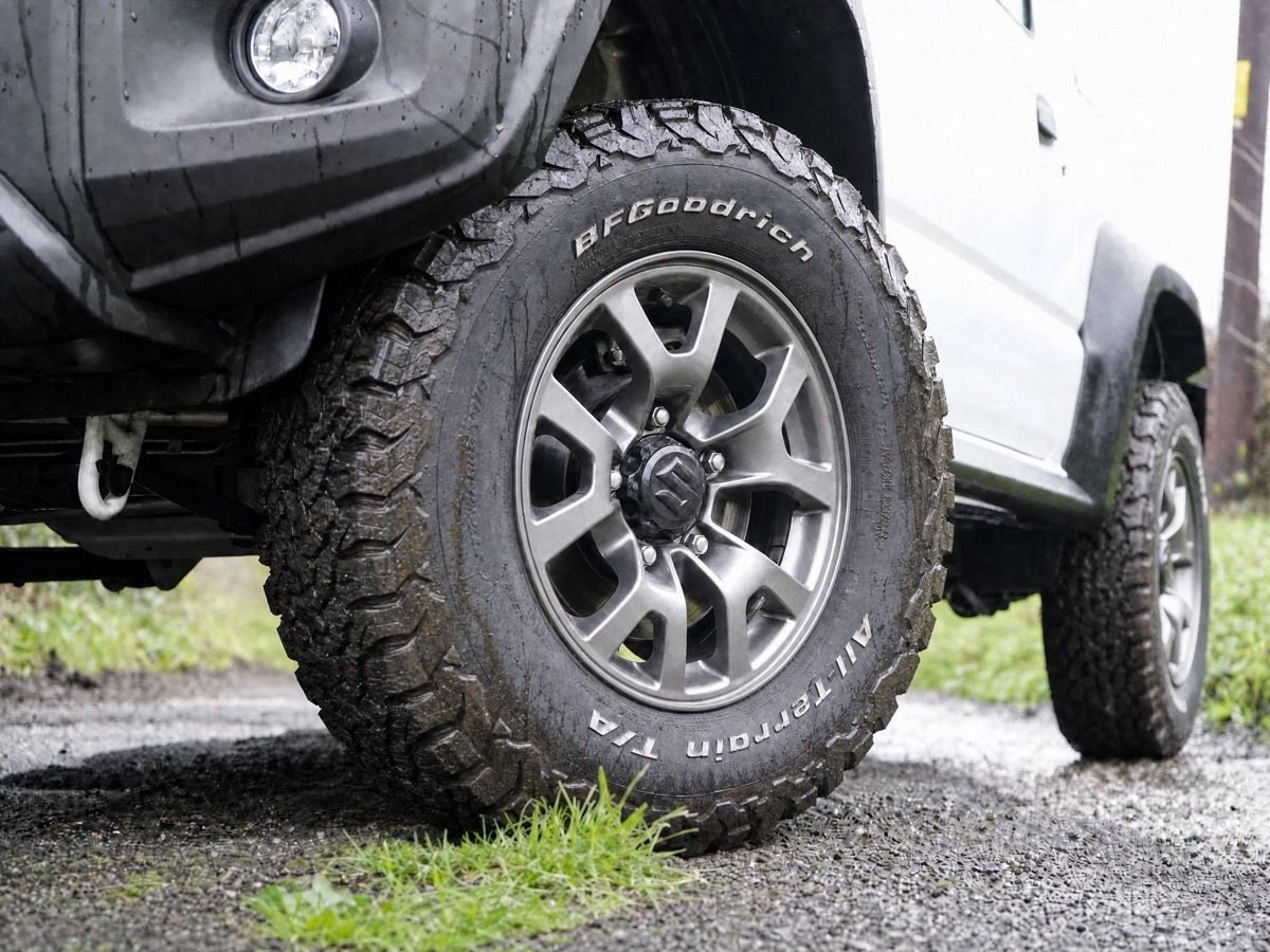 A BFGoodrich All-Terrain T/A tyre fitted to a Suzuki Jimny on a stock 15-inch alloy rim