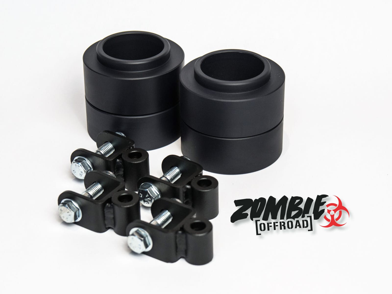A set of Zombie Offroad coil spacers and shock spacers laid out on a white background